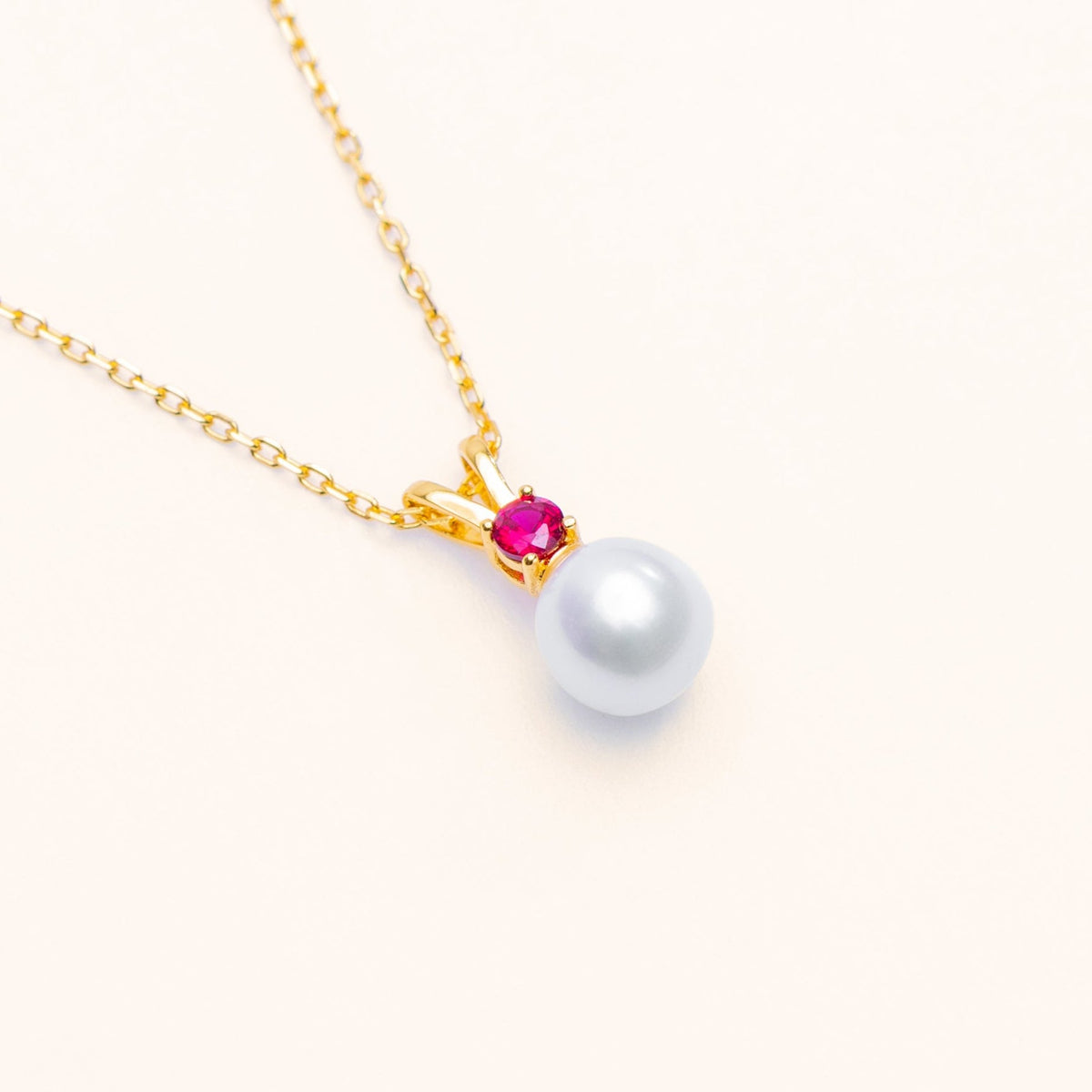 Halo freshwater pearl pendant with a red lab-grown ruby in sterling silver and 18k gold